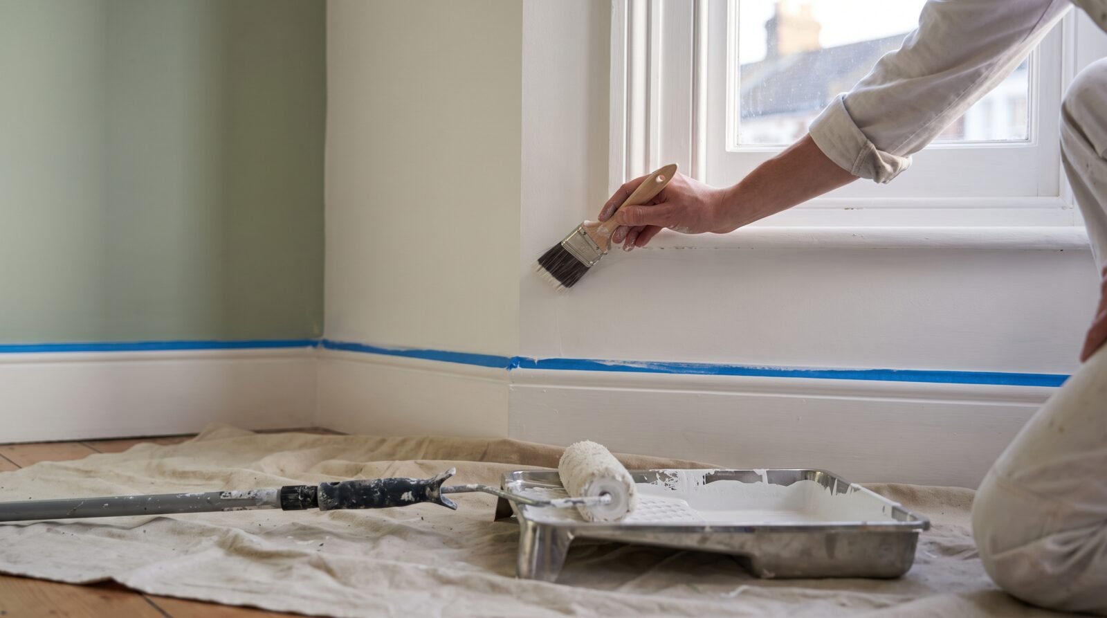 Representative visual of a brush cutting in a crisp line between wall and woodwork